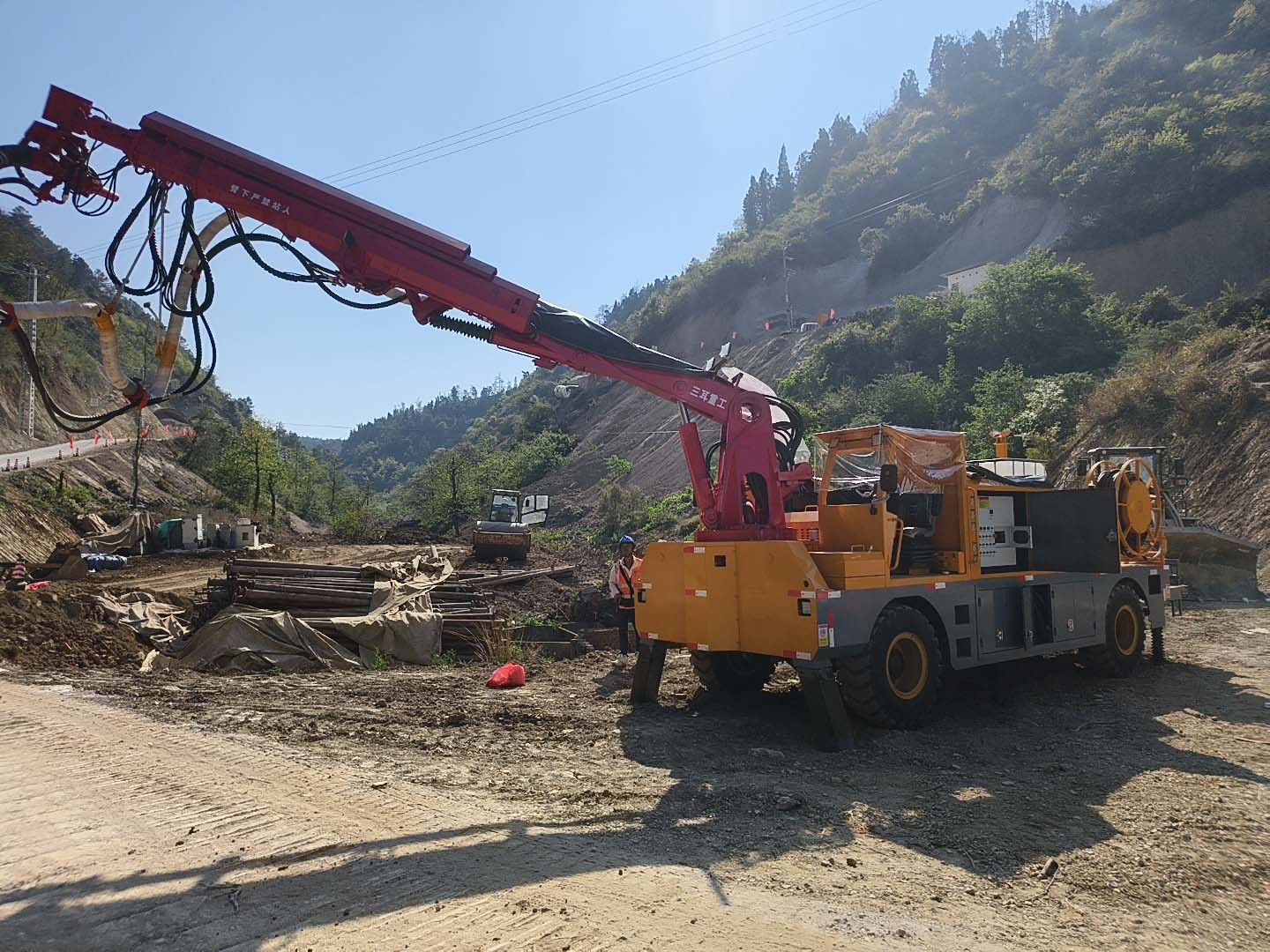 A wet shotcrete machine is spraying concrete onto the tunnel surface A wet shotcrete machine is spraying concrete onto the tunnel surface